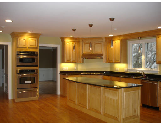 95 Reed Street Lexington, MA 02421 - Photo 2 of 8 a kitchen with stainless steel appliances granite countertop a sink and a refrigerator