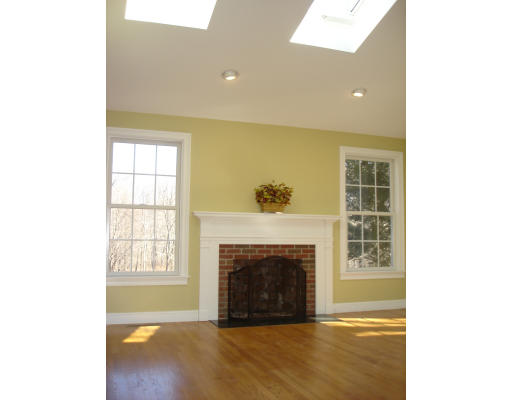 95 Reed Street Lexington, MA 02421 - Photo 5 of 8 a living room with a fireplace and a floor