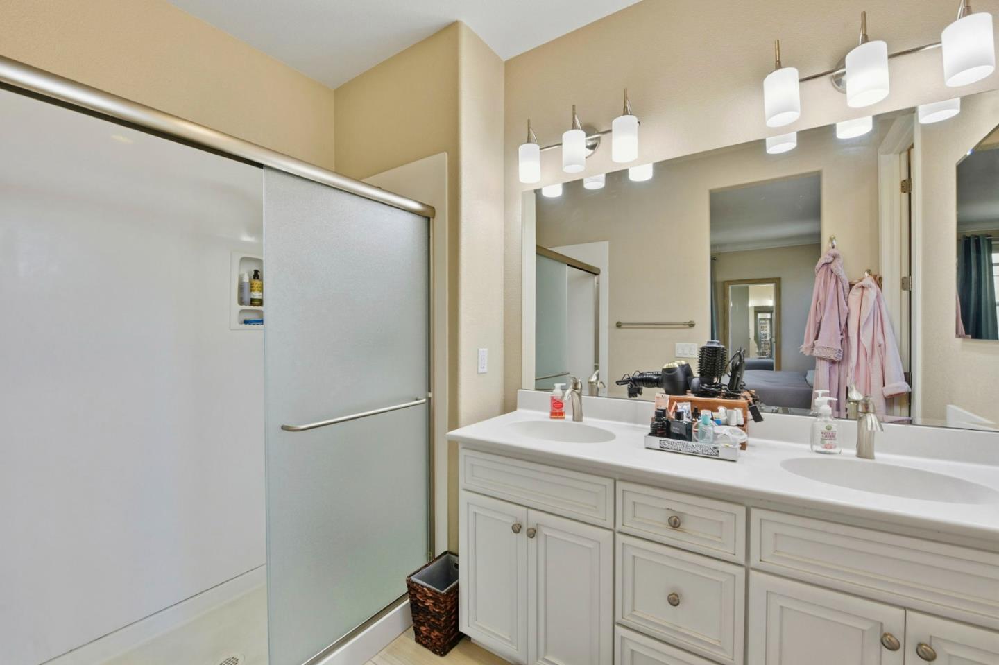 56 Regency Place Hayward, CA 94544 - Photo 27 of 43 a bathroom with a sink a mirror and a shower