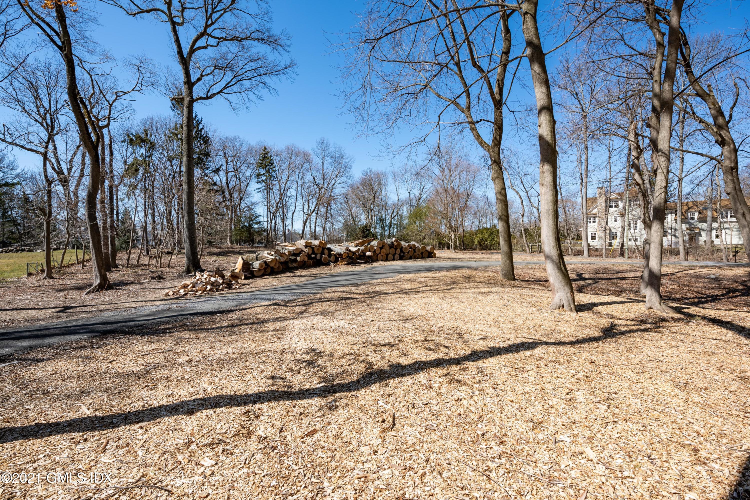 26 Red Top Road Riverside, CT 06878 - Photo 5 of 8 a view of a yard with snow on the road