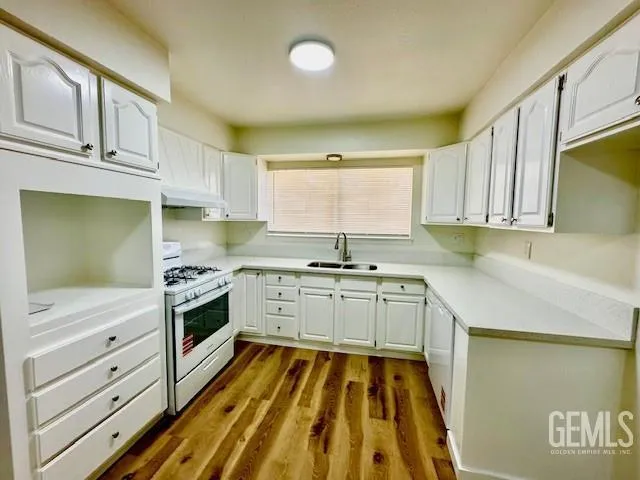 a kitchen with stainless steel appliances a refrigerator and a stove top oven