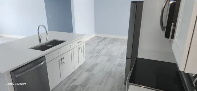 a kitchen with a sink and a stove top oven