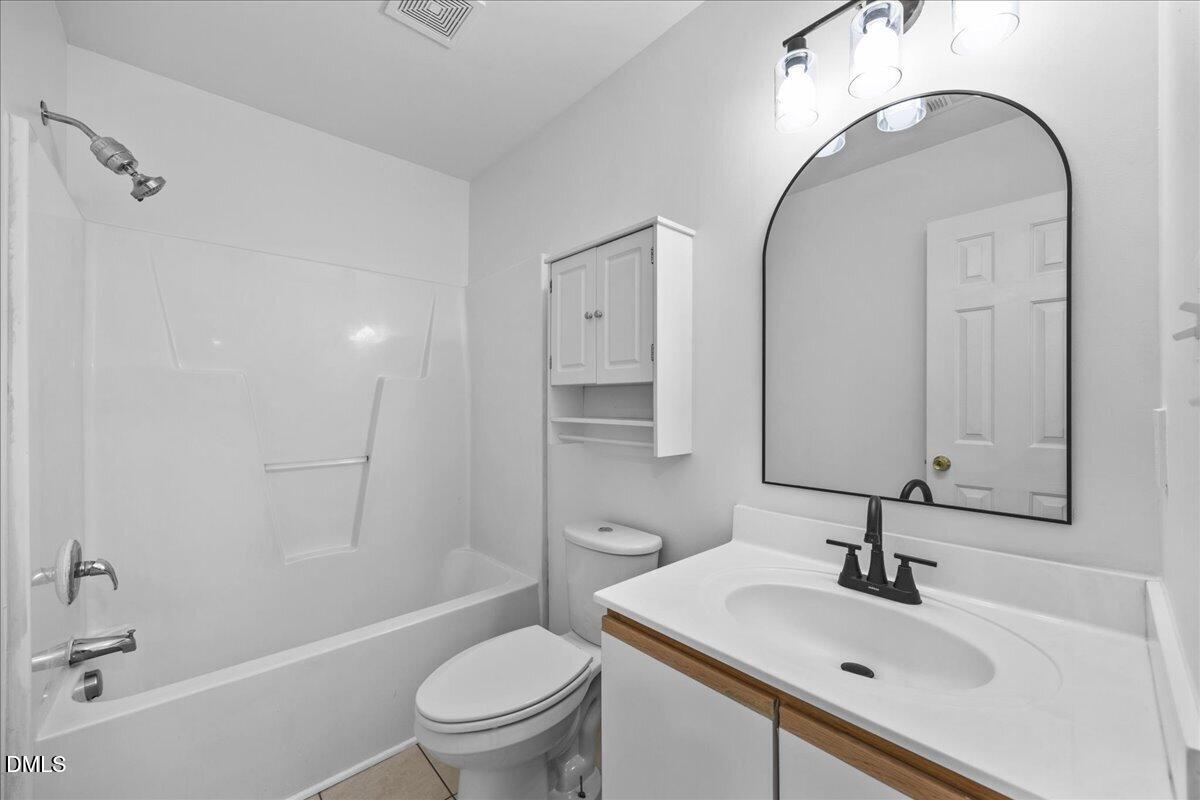 3831 Pin Oak Road Raleigh, NC 27604 - Photo 17 of 28 a bathroom with a sink toilet and shower