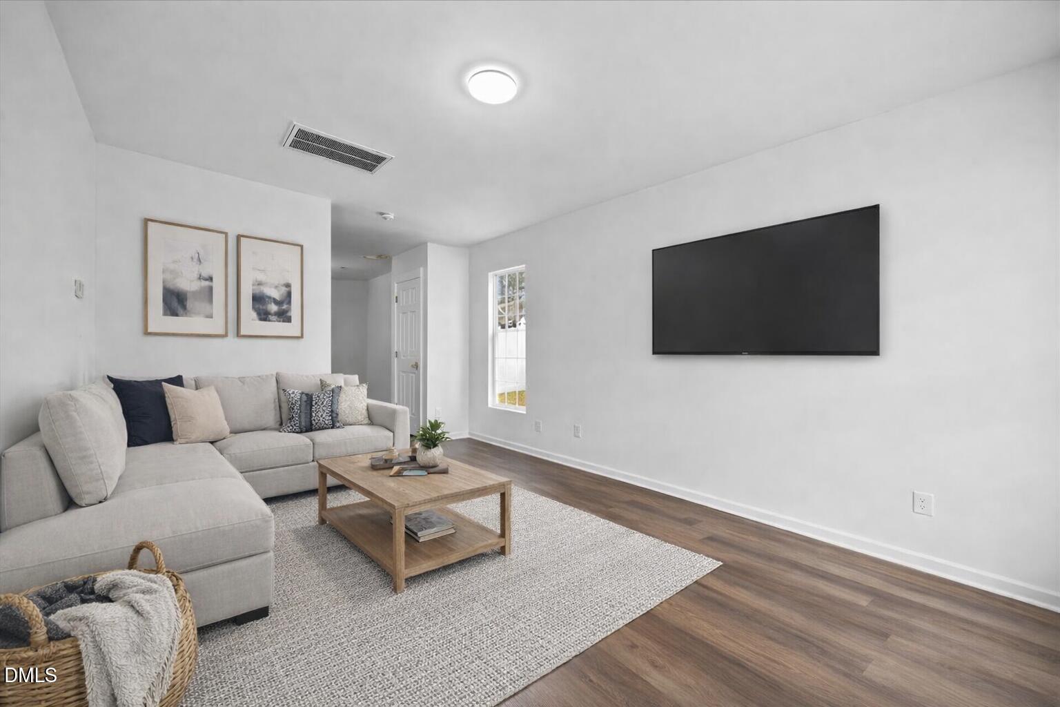 3831 Pin Oak Road Raleigh, NC 27604 - Photo 2 of 28 a living room with furniture and a flat screen tv