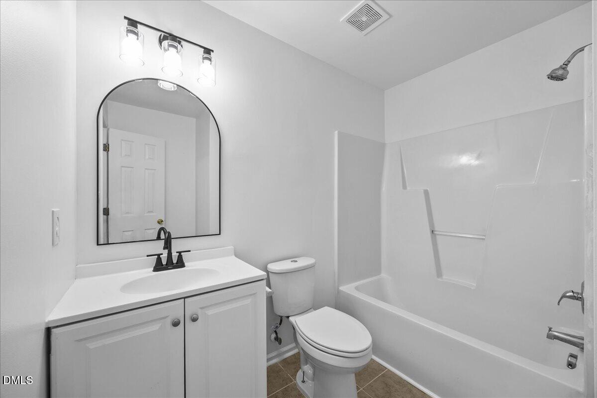 3831 Pin Oak Road Raleigh, NC 27604 - Photo 23 of 28 a bathroom with a sink toilet and shower