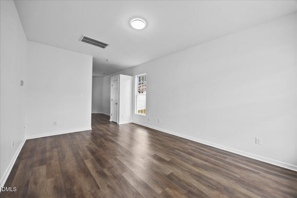 3831 Pin Oak Road Raleigh, NC 27604 - Photo 3 of 28 a view of an empty room and wooden floor