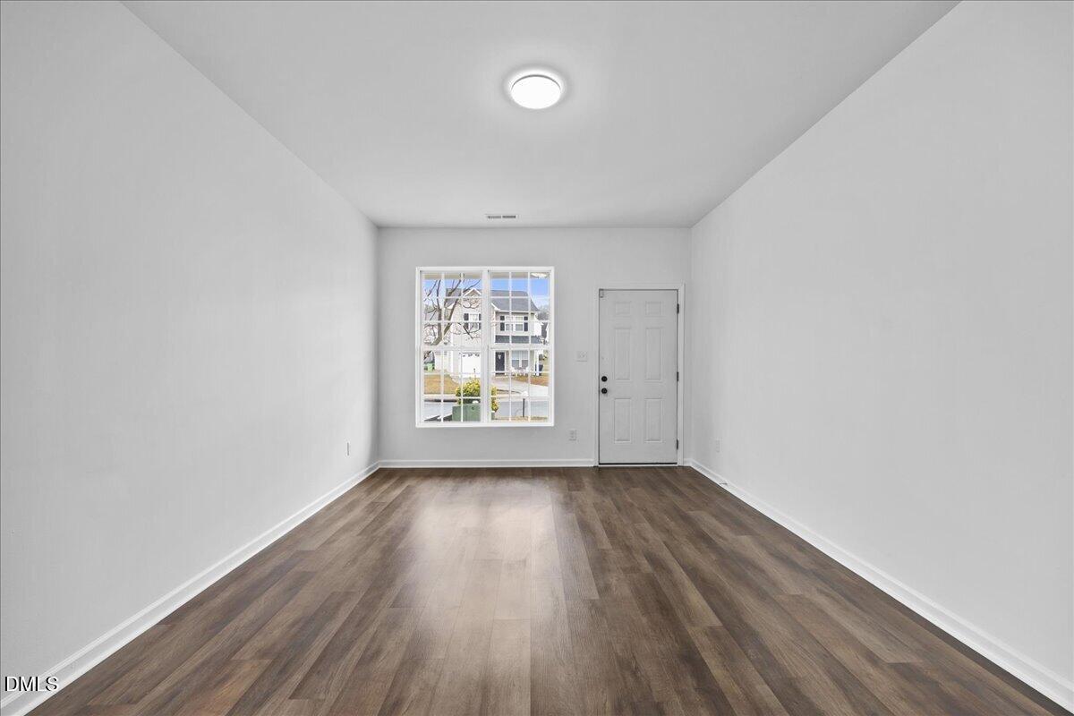 3831 Pin Oak Road Raleigh, NC 27604 - Photo 4 of 28 an empty room with wooden floor and windows