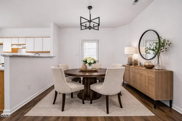 a view of a dining room with furniture window and wooden floor