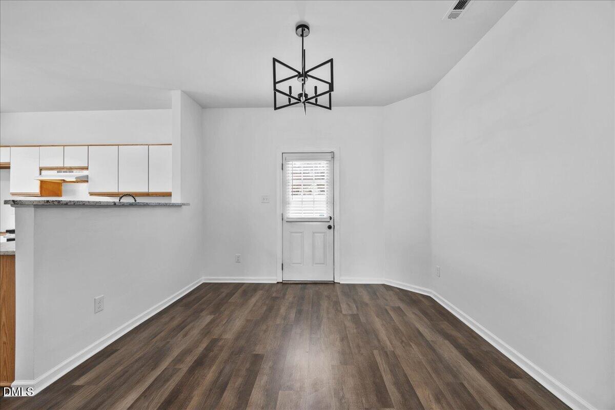 3831 Pin Oak Road Raleigh, NC 27604 - Photo 6 of 28 a view of a kitchen with wooden floor and window