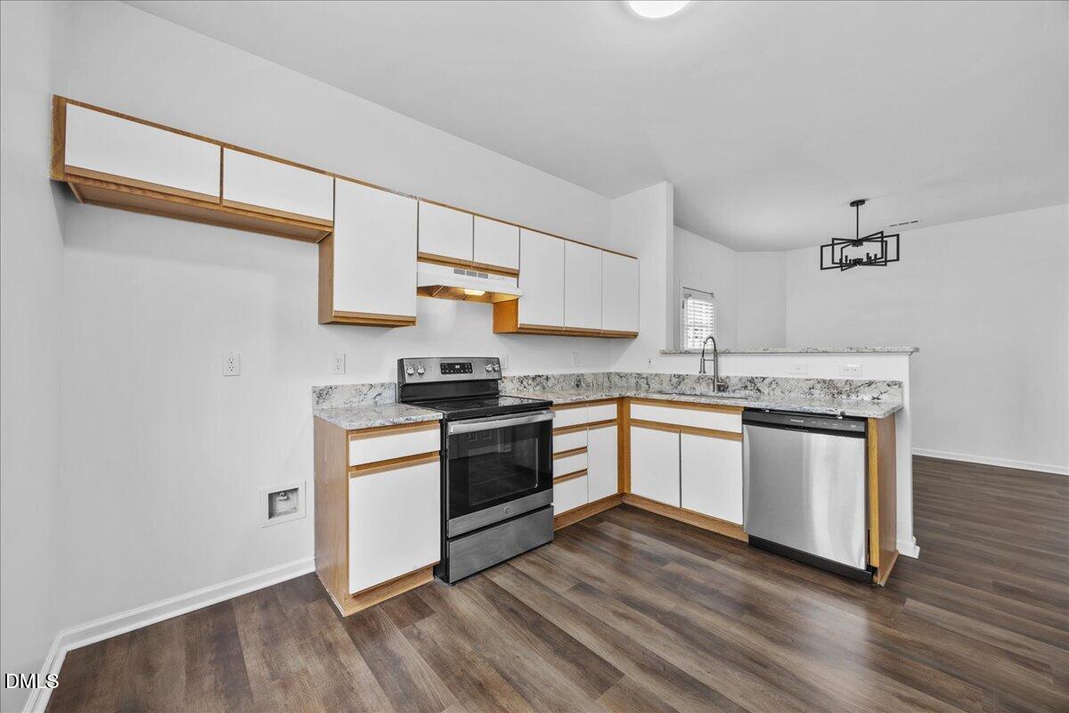3831 Pin Oak Road Raleigh, NC 27604 - Photo 8 of 28 a kitchen with a white cabinets and white appliances