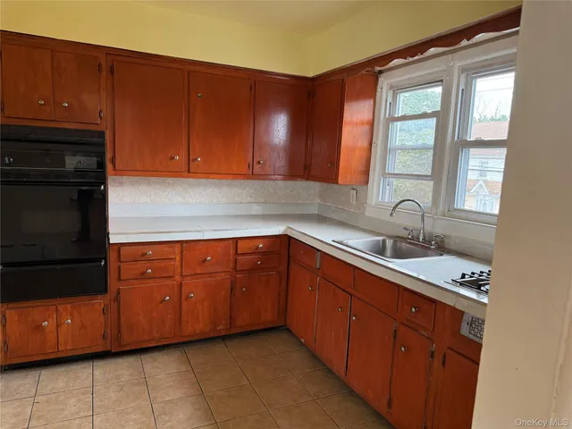 a kitchen with stainless steel appliances granite countertop a sink stove and cabinets