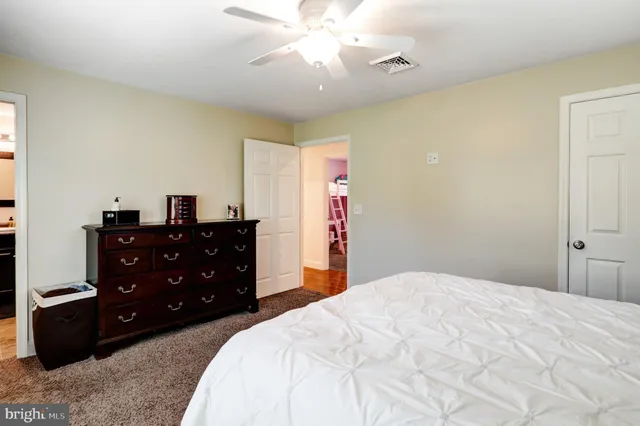 a bedroom with a bed and a dresser