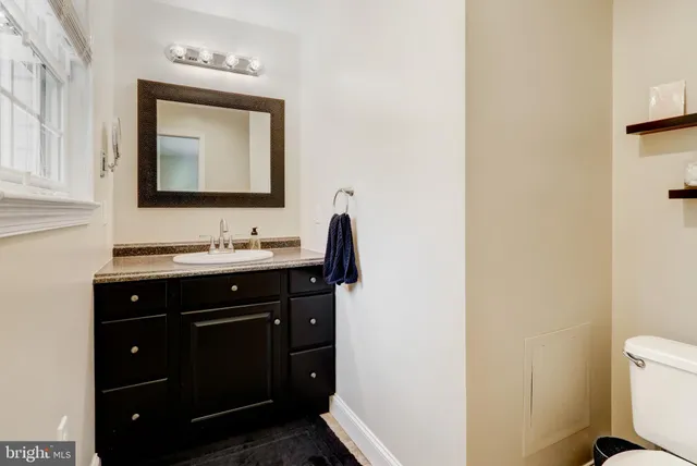 a bathroom with a sink vanity and a mirror