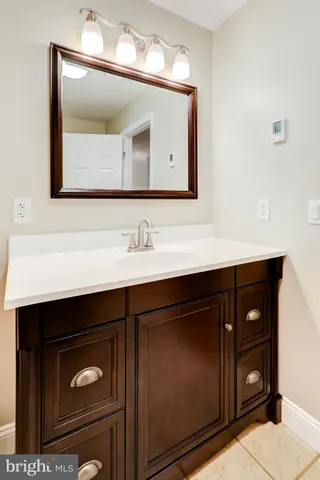 a bathroom with a sink vanity and mirror
