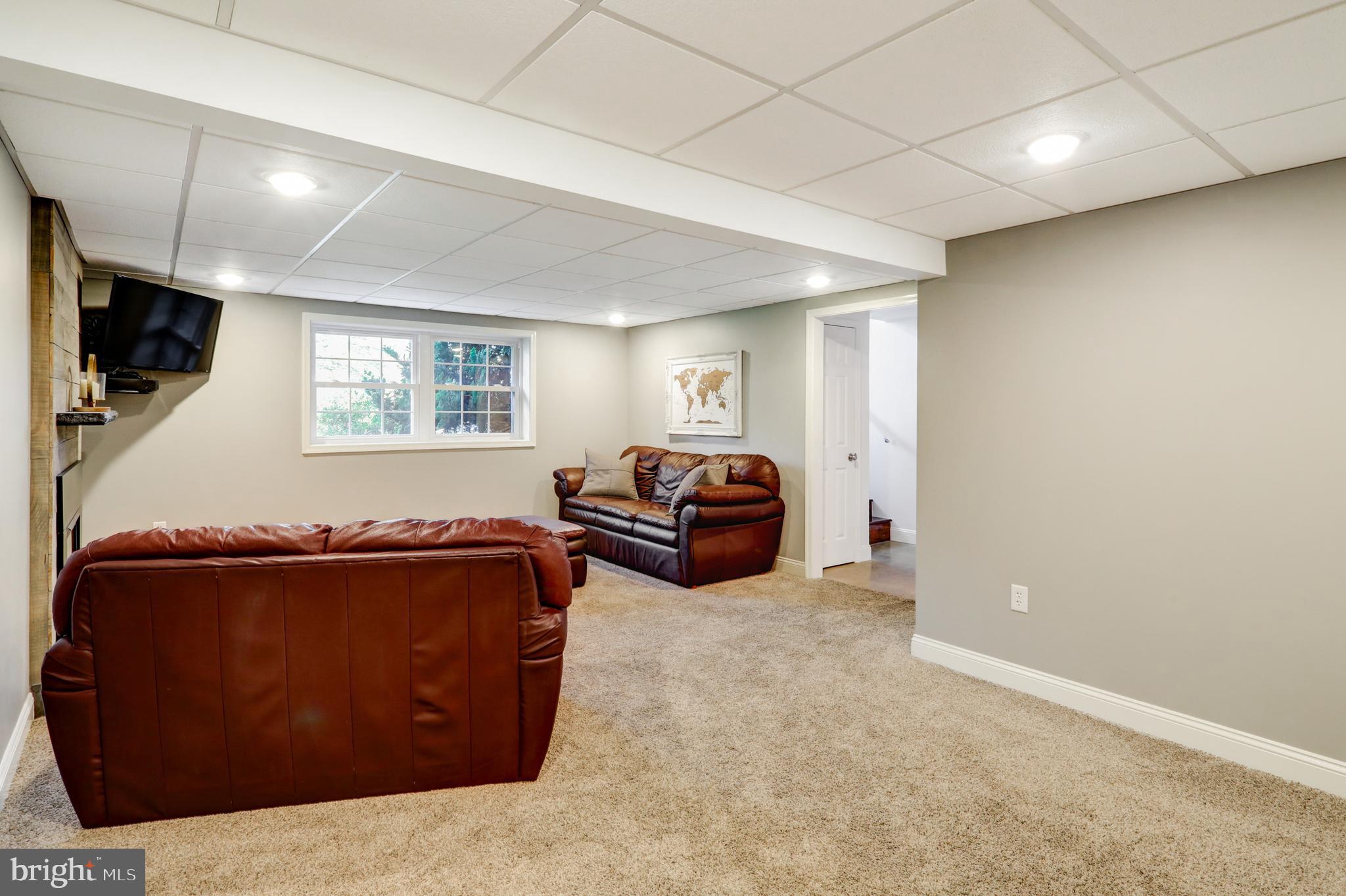 2771 Camp Road Manheim, PA 17545 - Photo 32 of 45 a living room with furniture a flat screen tv and windows