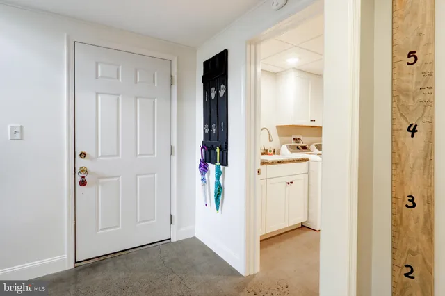 a view of washer and dryer with kitchen view