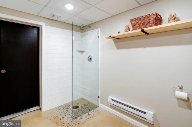a view of a patio with couches table and chairs and wooden fence