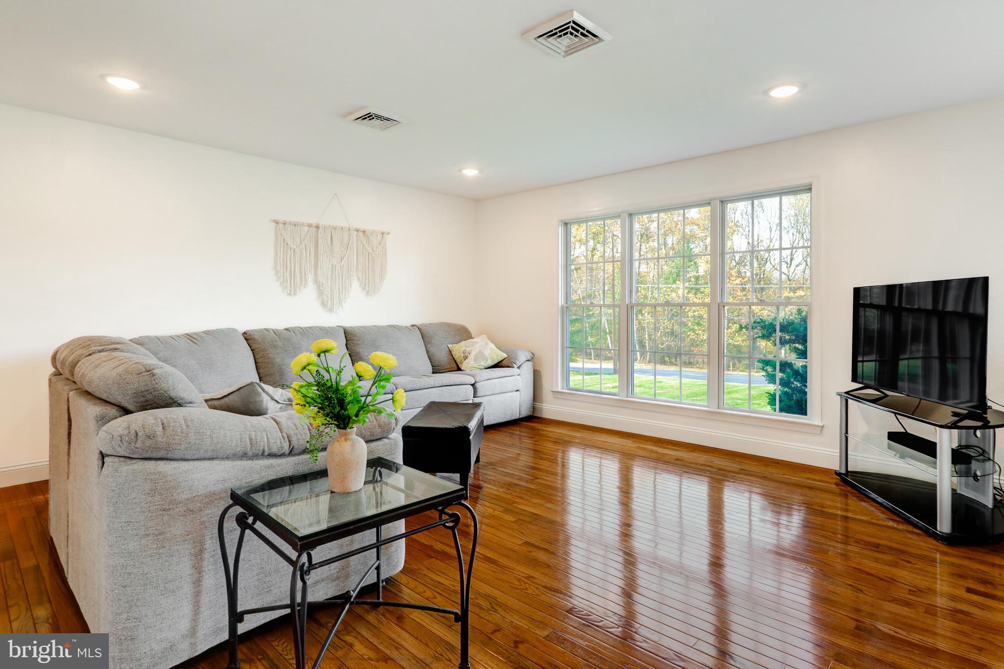 2771 Camp Road Manheim, PA 17545 - Photo 7 of 45 a living room with furniture flat screen tv and a large window