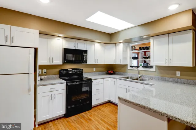 a kitchen with a sink a stove and refrigerator