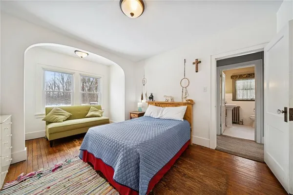 a bedroom with two beds and a window