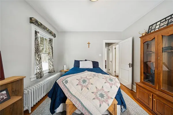 a bedroom with a bed and a window