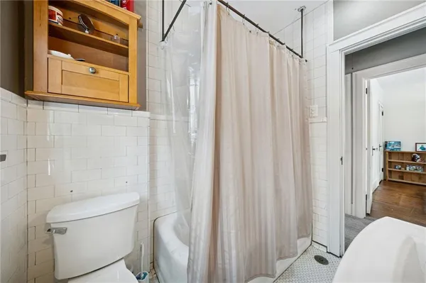 a bathroom with a toilet a sink and a shower