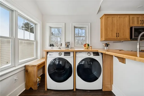 a utility room with sink dryer and washer