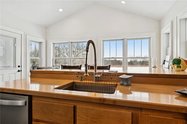 a kitchen with a sink a counter and cabinets
