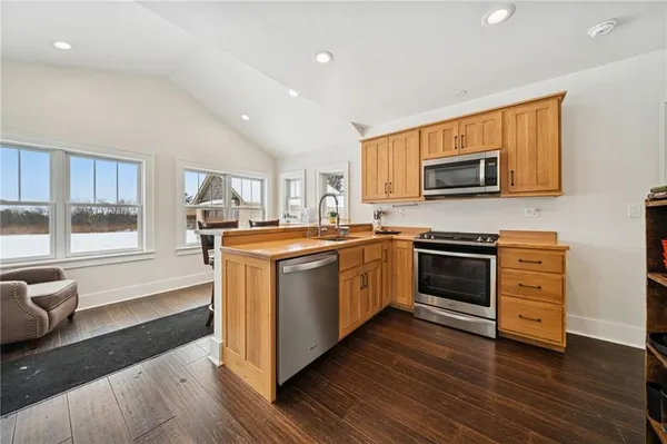 a kitchen with stainless steel appliances a stove a sink and a microwave
