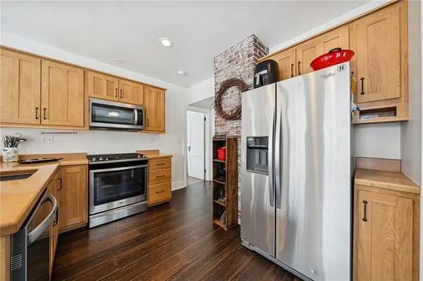a kitchen with stainless steel appliances and wooden cabinets