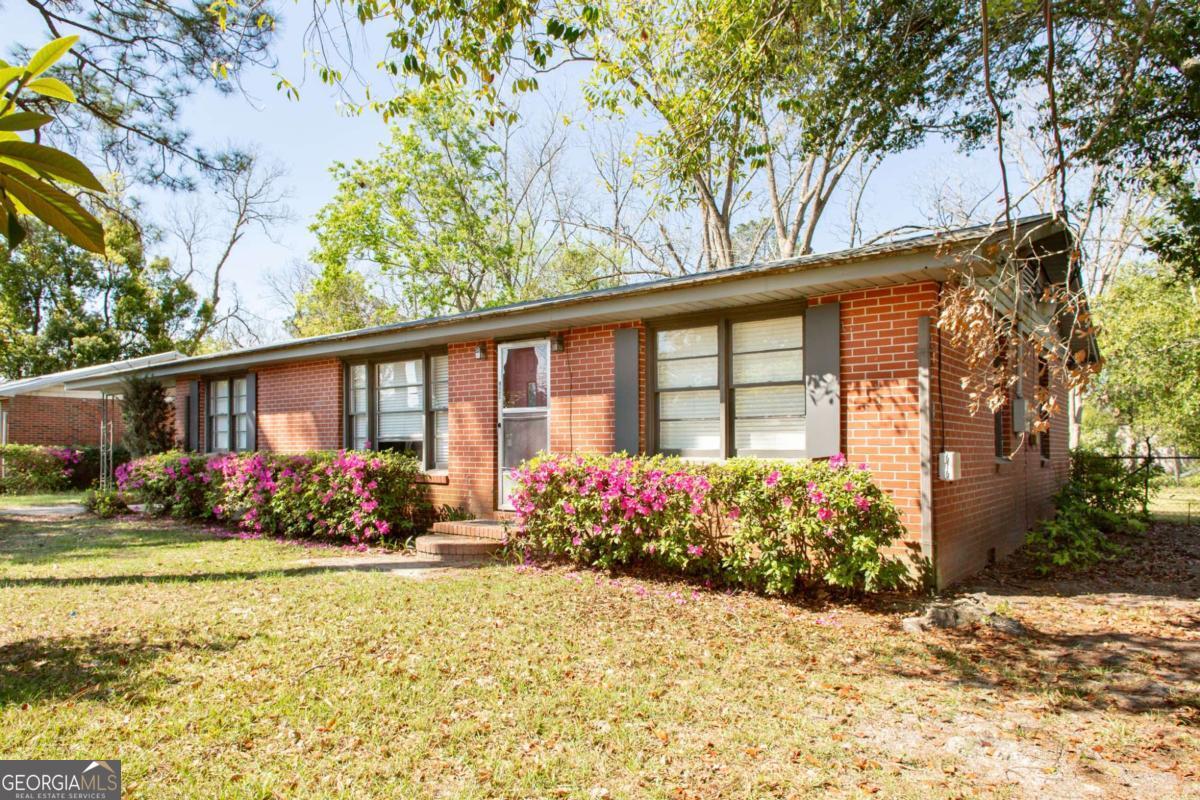 1329 Gorman Road Waycross, GA 31503 - Photo 1 of 23 a front view of a house with garden