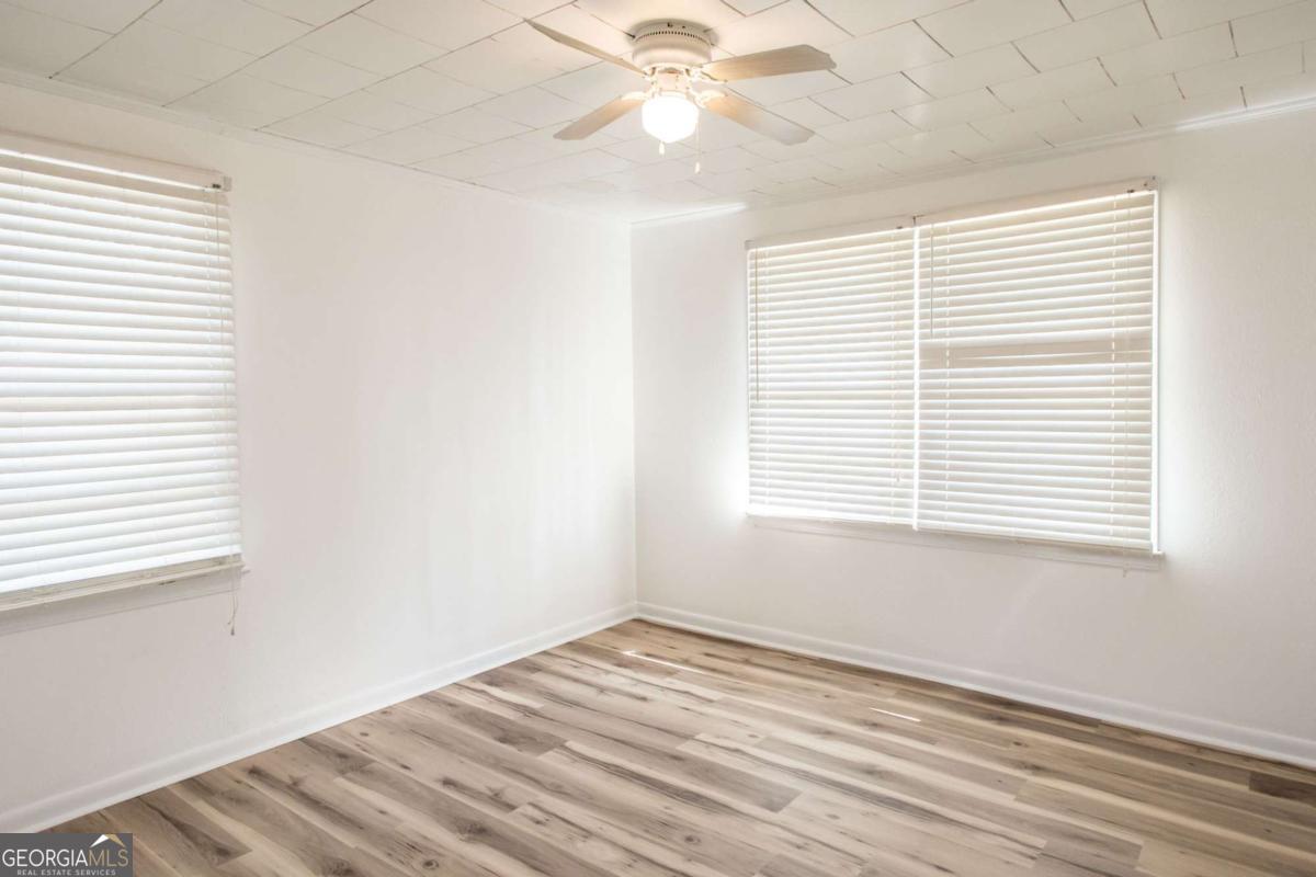 1329 Gorman Road Waycross, GA 31503 - Photo 14 of 23 a view of an empty room with wooden floor and a window