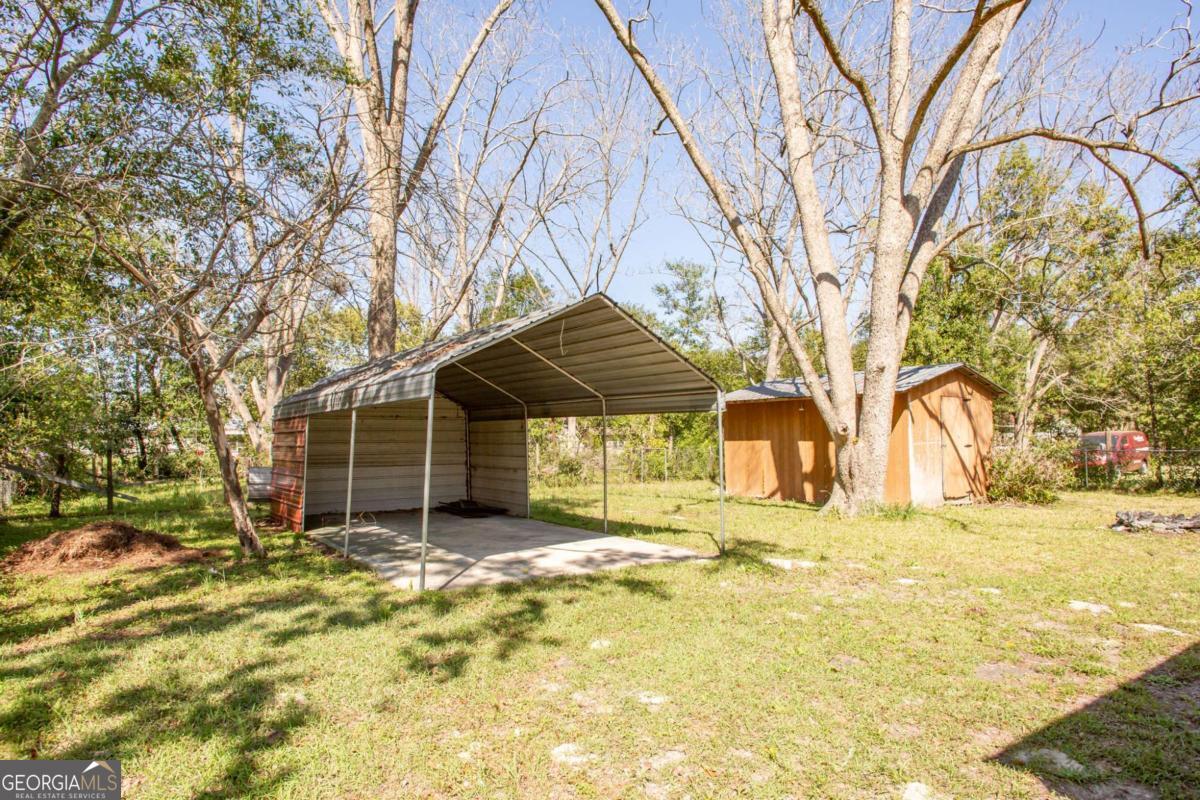 1329 Gorman Road Waycross, GA 31503 - Photo 22 of 23 a yellow house in middle of the forest