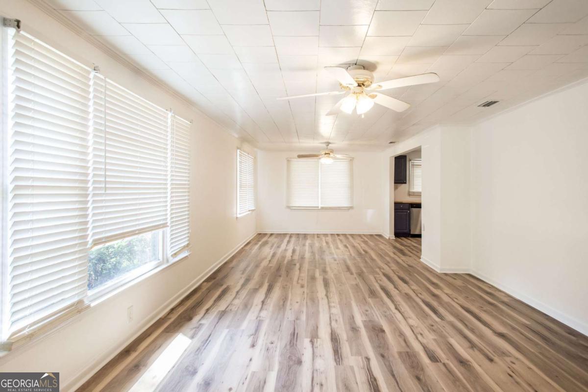 1329 Gorman Road Waycross, GA 31503 - Photo 3 of 23 wooden floor in an empty room with a window