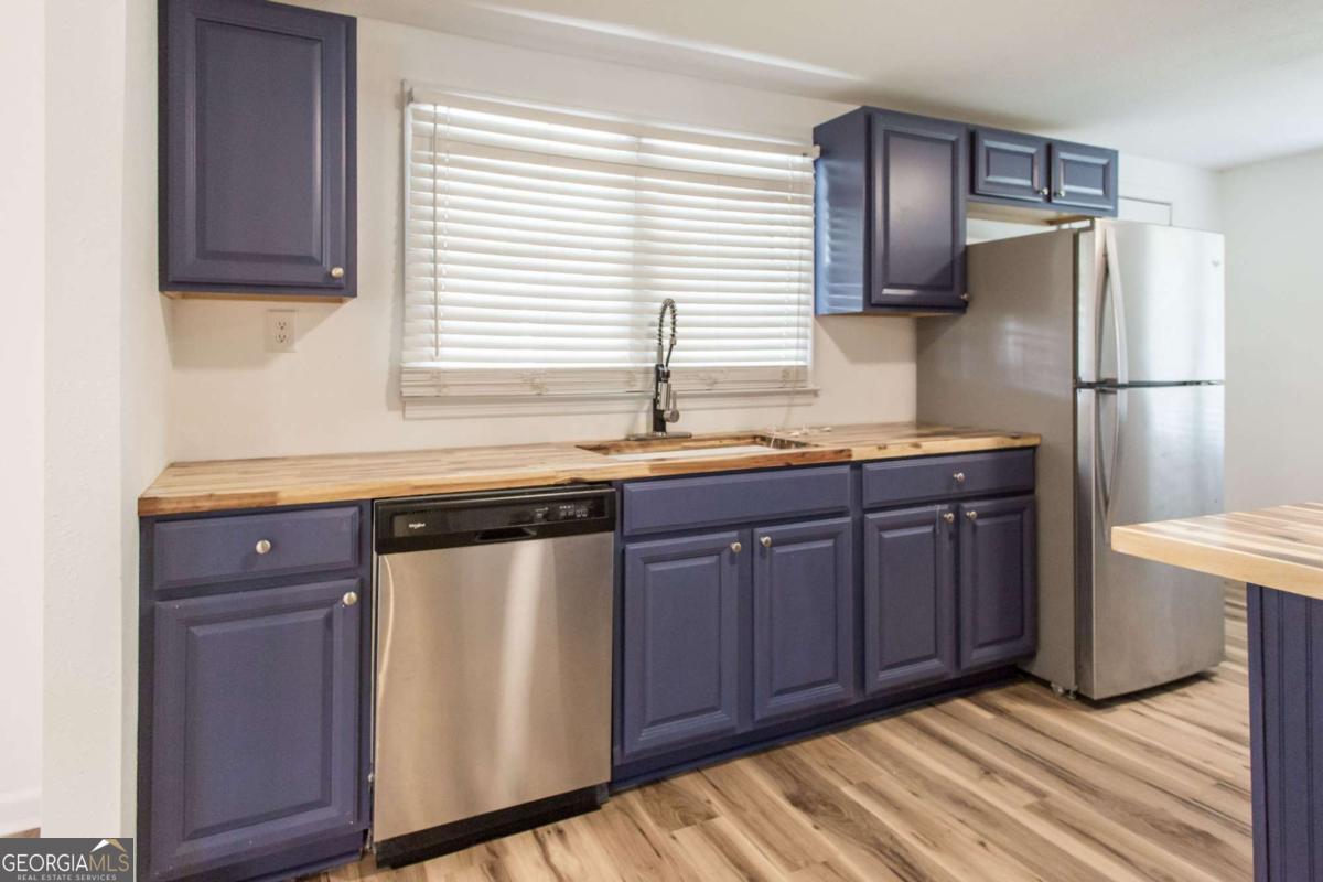 1329 Gorman Road Waycross, GA 31503 - Photo 7 of 23 a kitchen with stainless steel appliances granite countertop a sink stove and refrigerator