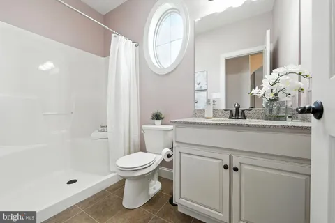 a bathroom with a toilet a sink and a mirror