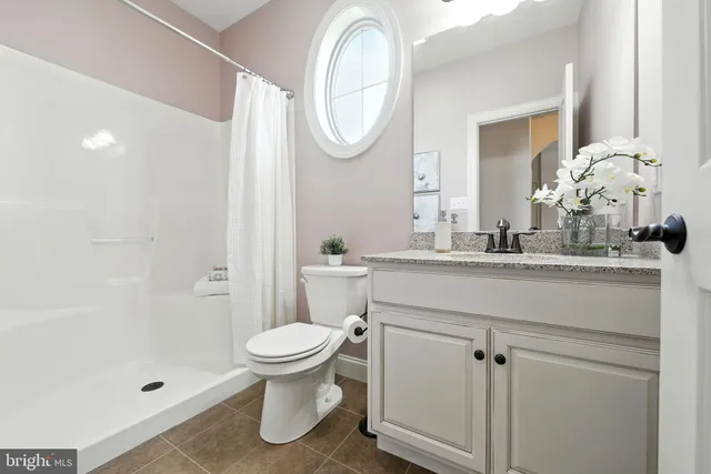 a bathroom with a toilet a sink and a mirror