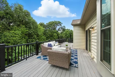 a view of a deck with couches and wooden floor