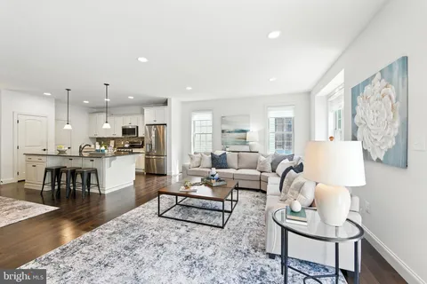 a living room with furniture and kitchen view