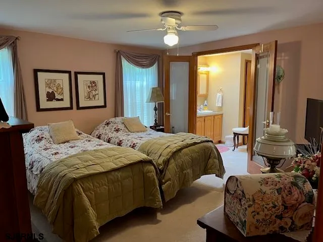 a bedroom with bed and a large window