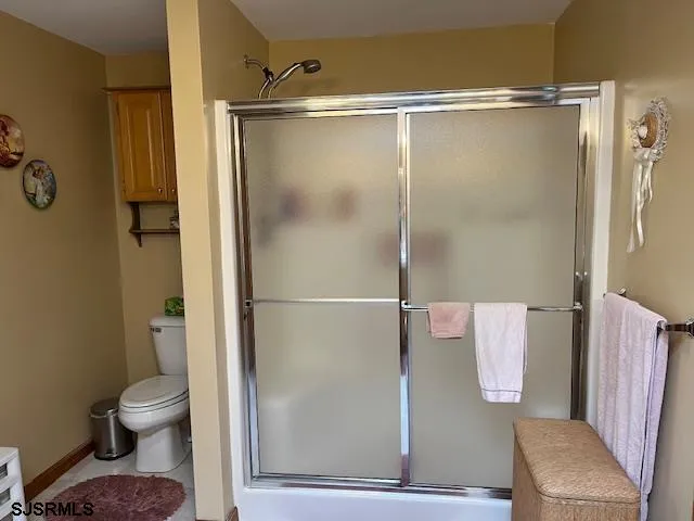 a bathroom with a shower and a toilet
