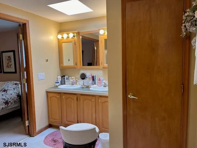 a bathroom with a sink a toilet and mirror