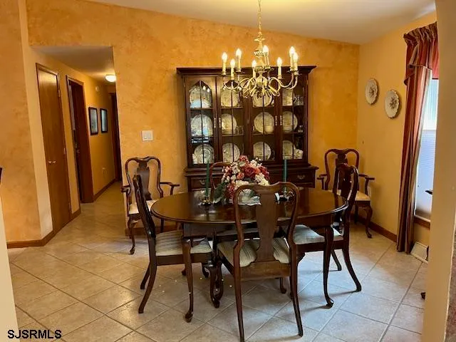 a view of a dining room with furniture and chandelier