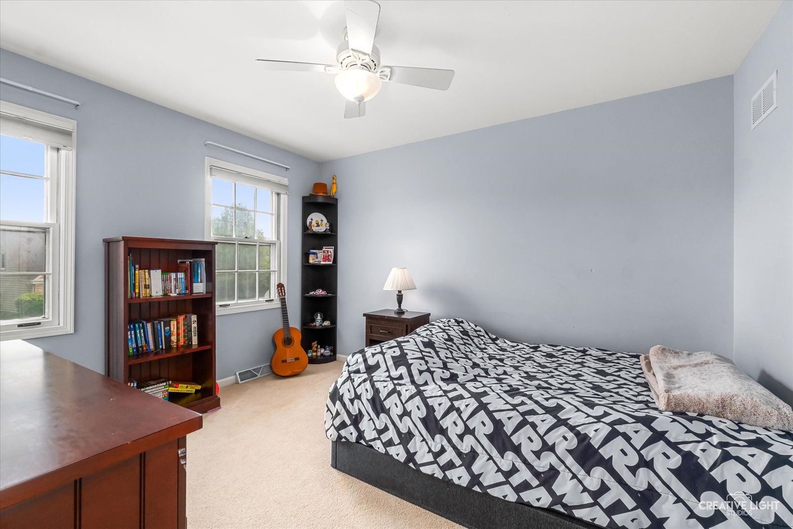 27W343 Churchill Road Winfield, IL 60190 - Photo 15 of 40 a bedroom with a large bed and a book shelf