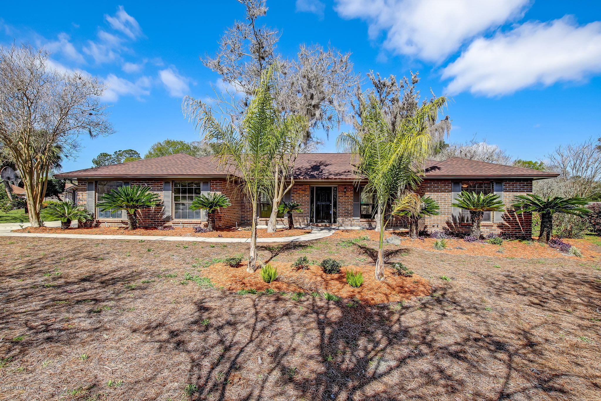 350 Foxridge Road Orange Park, FL 32065 - Photo 1 of 54 a patio with a table and chairs under an umbrella