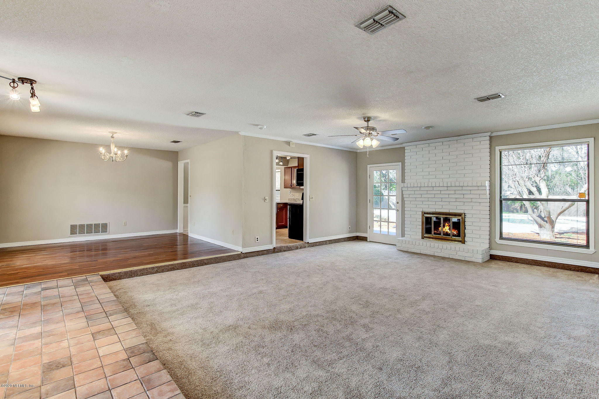 350 Foxridge Road Orange Park, FL 32065 - Photo 11 of 54 a view of an empty room with a fireplace and a window