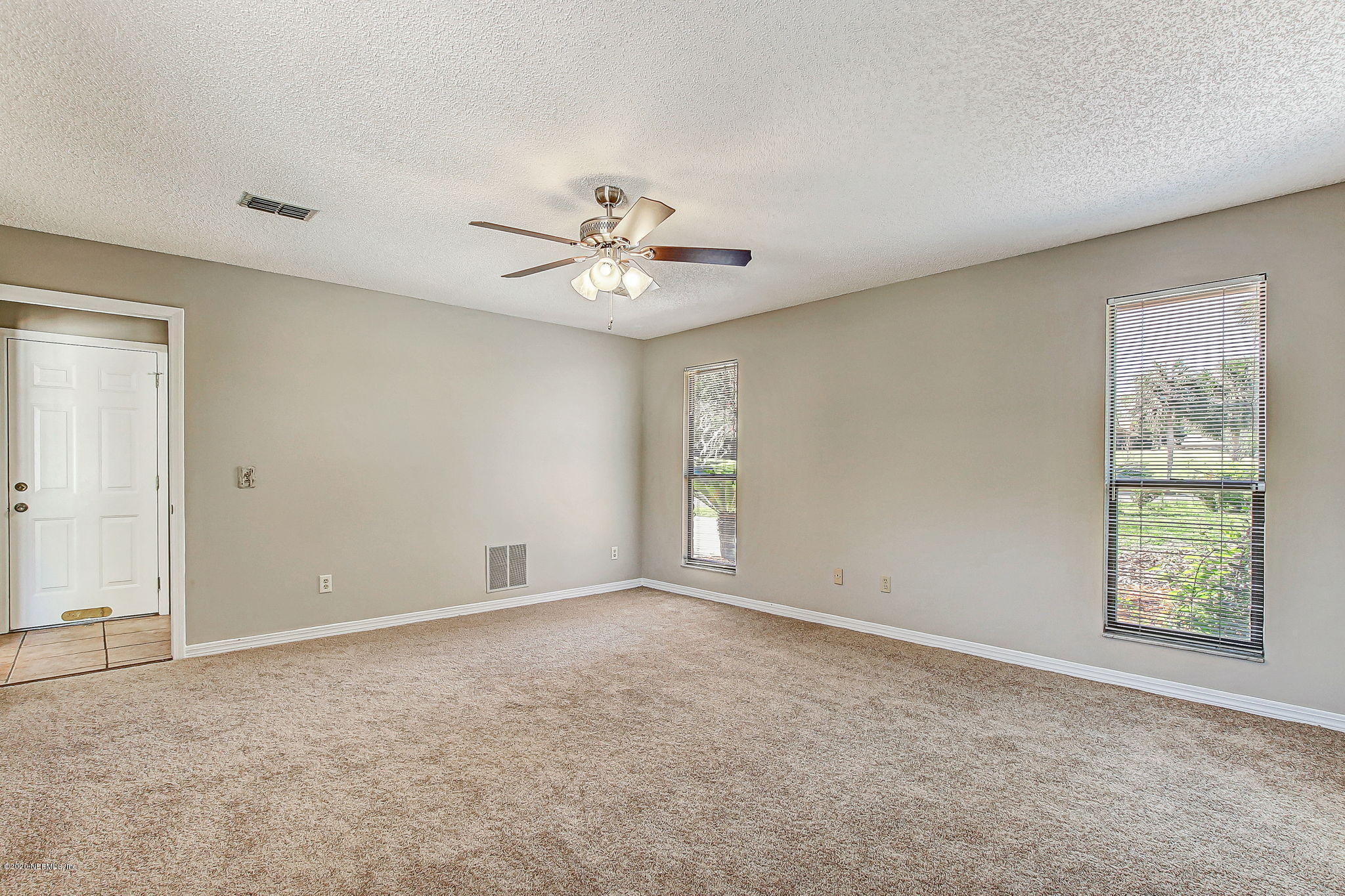 350 Foxridge Road Orange Park, FL 32065 - Photo 13 of 54 an empty room with windows and fan