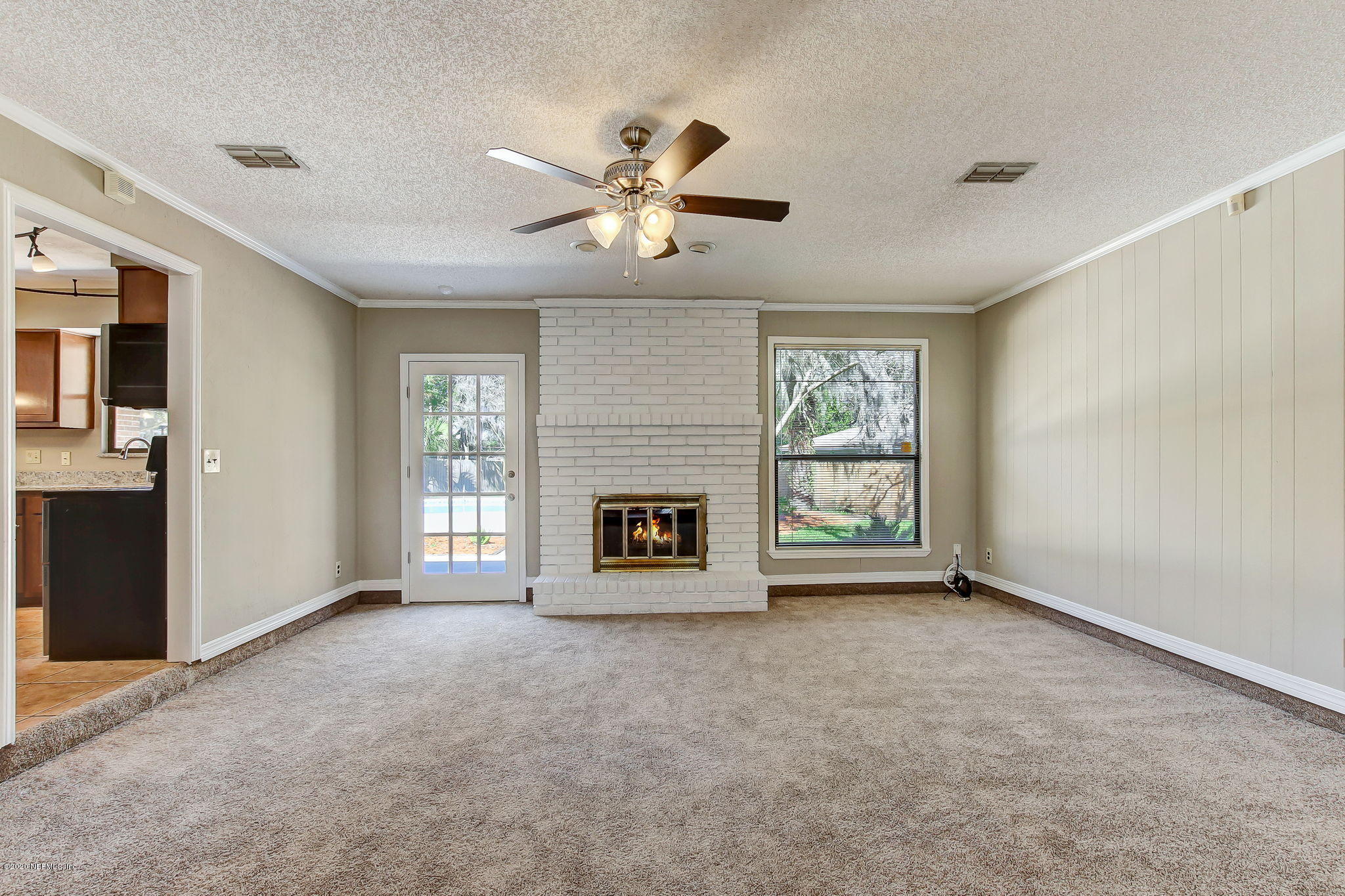 350 Foxridge Road Orange Park, FL 32065 - Photo 34 of 54 a view of an empty room with a fireplace and a window