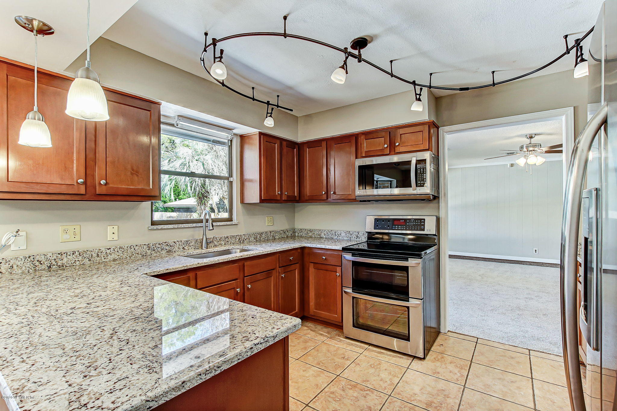 350 Foxridge Road Orange Park, FL 32065 - Photo 4 of 54 a kitchen with stainless steel appliances granite countertop a sink a stove a microwave a refrigerator and cabinets