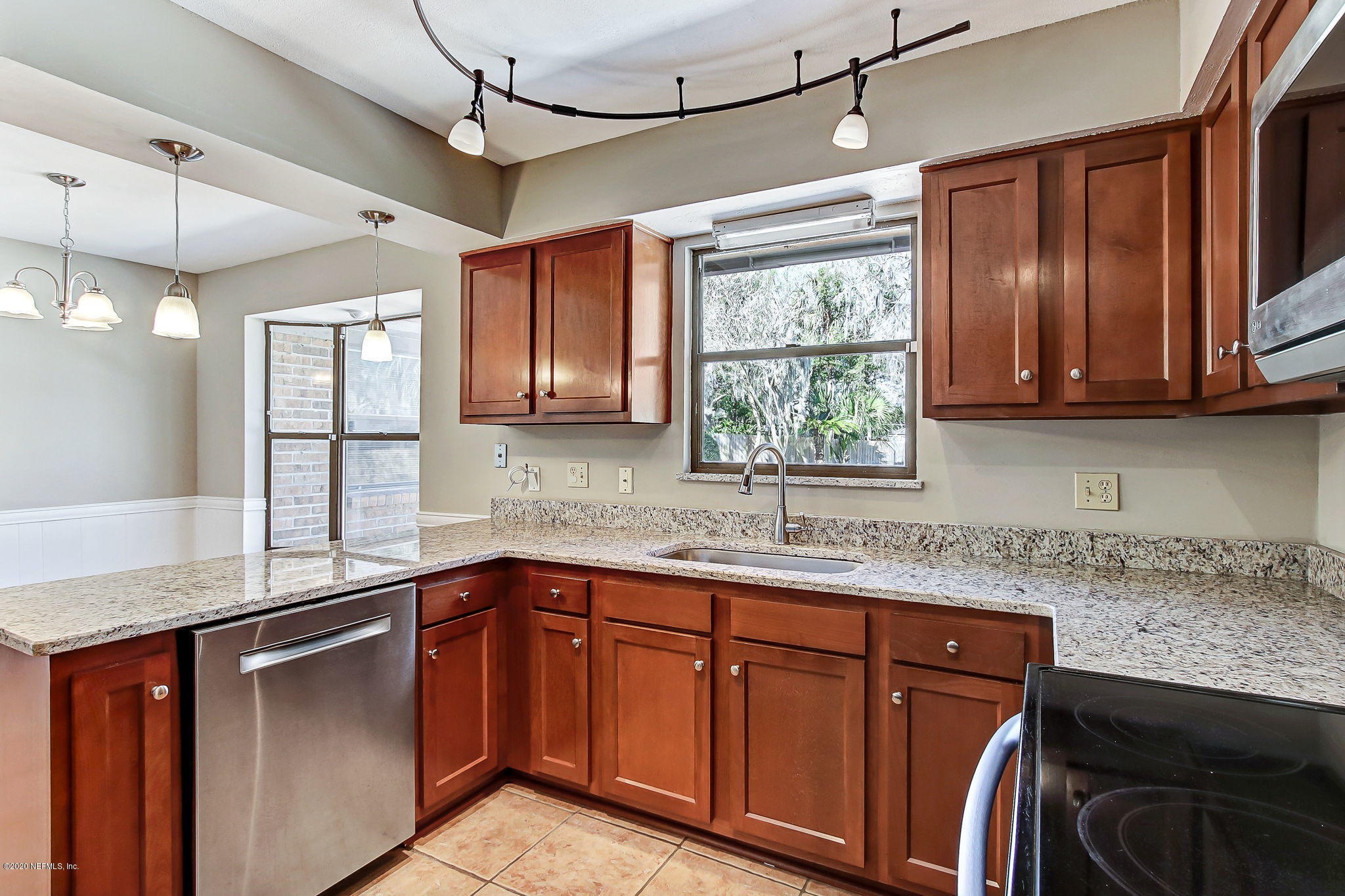 350 Foxridge Road Orange Park, FL 32065 - Photo 5 of 54 a kitchen with stainless steel appliances granite countertop cabinets sink and window